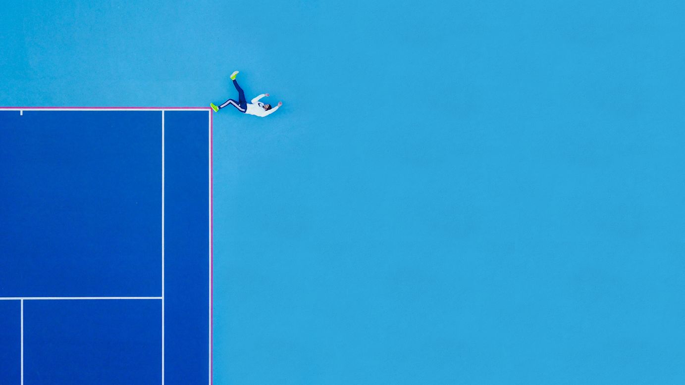 <strong>Match point:</strong> The first prize in the people category went to Martin Sanchez who took this image of a tennis player lying on a court in New Jersey. "While driving, I noticed an empty tennis court that just stood out like a treasured story in a book of empty words," says Sanchez. But it was the tennis player who made the image pop.