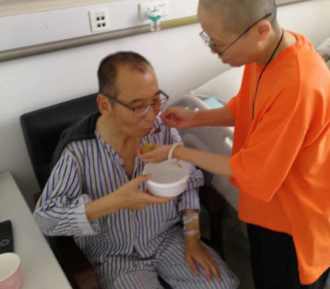 In this recent undated handout photo, Liu Xiaobo, left, is attended to by his wife Liu Xia in a hospital in China.