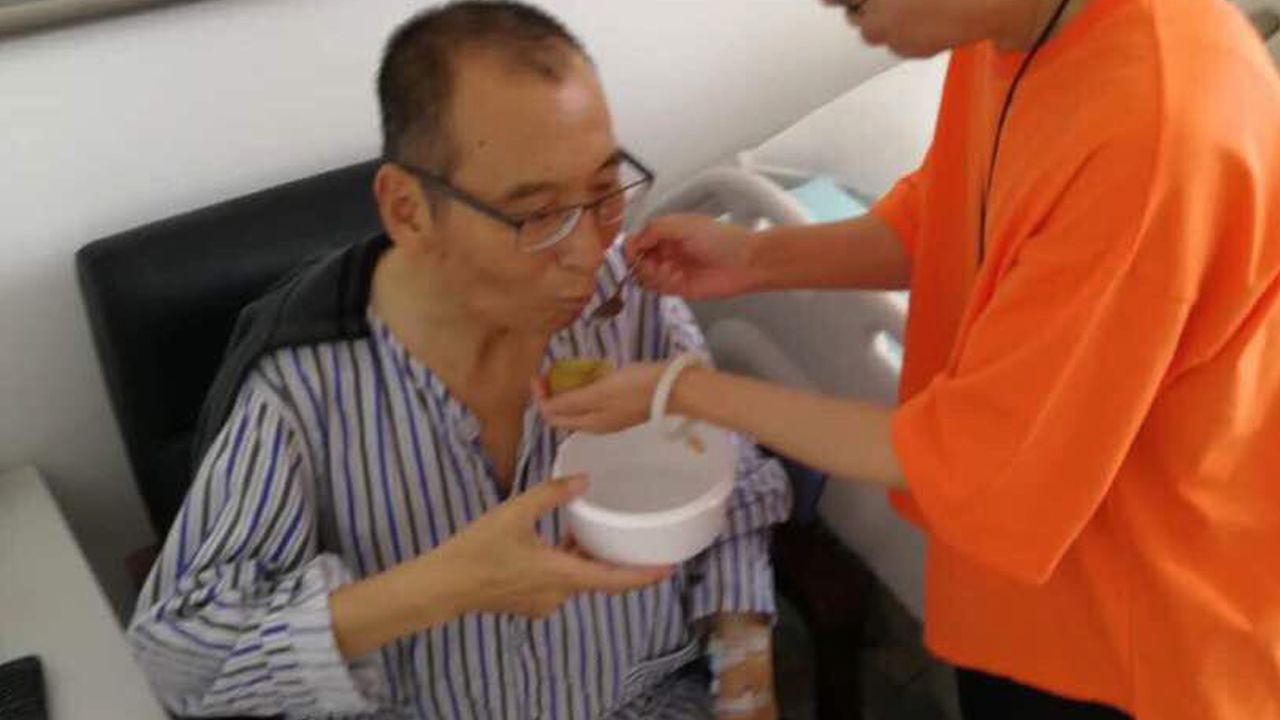 In this recent undated handout photo, Liu Xiaobo, left, is attended to by his wife Liu Xia in a hospital in China.