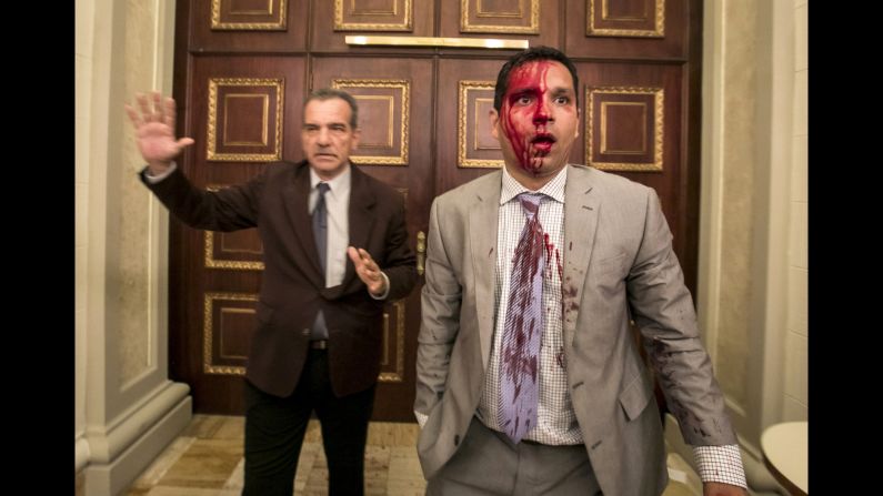 Venezuelan lawmakers Luis Stefanelli, left, and Jose Regnault appear stunned in a corridor of the National Assembly after <a href="index.php?page=&url=http%3A%2F%2Fwww.cnn.com%2F2017%2F07%2F05%2Famericas%2Fvenezuela-indepedence-day-clashes%2Findex.html" target="_blank">a clash with demonstrators</a> in Caracas on Wednesday, July 5. Supporters of Maduro stormed the building and attacked opposition lawmakers, witnesses said. At least seven legislative employees and five lawmakers were injured, according to National Assembly President Julio Borges. Journalists said they were also assaulted.