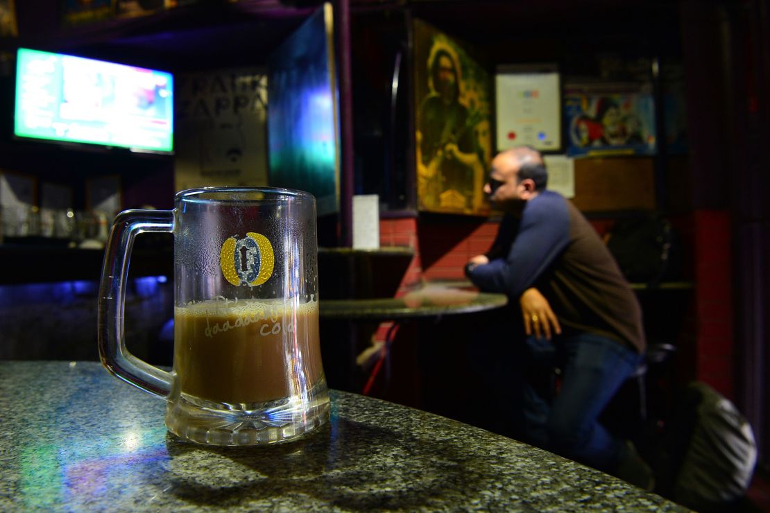 Drinkers are served coffee in a beer mug at Pecos, one of Bengaluru's oldest pubs.