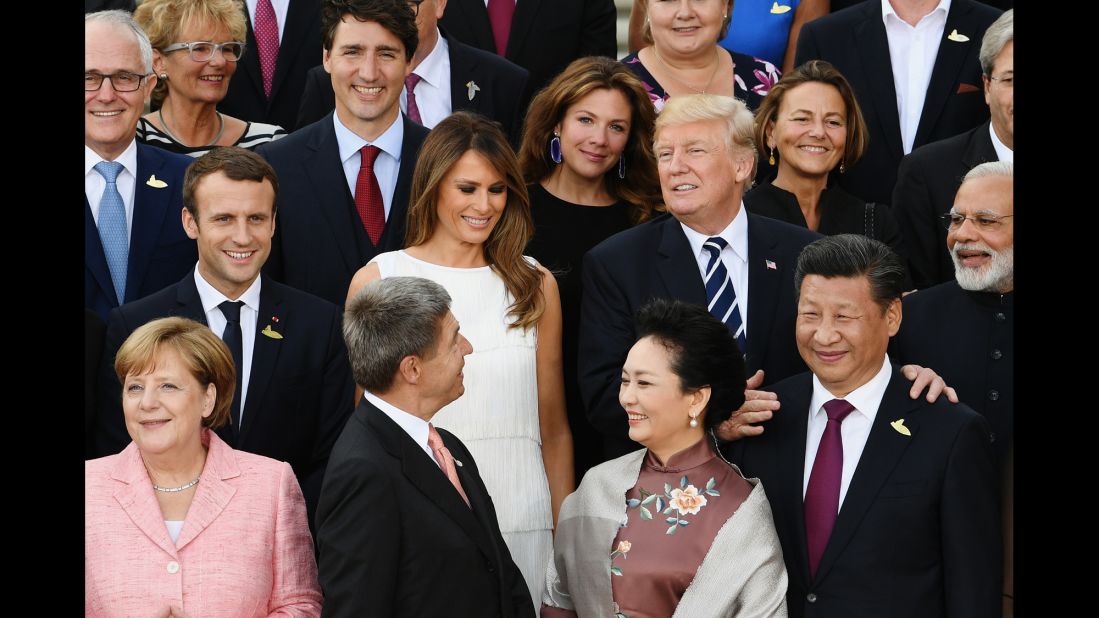 Trump joins world leaders and their partners as they pose for photos before the concert.