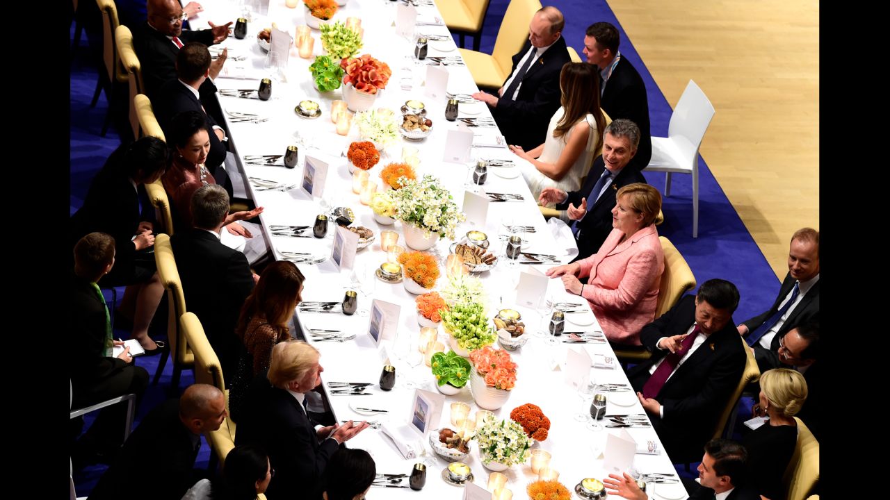 Germany's Merkel, center, right, hosts the banquet. At top right, Russian President Vladimir Putin sits next to US first lady Melania Trump. Donald Trump, bottom, left, across from Chinese President Xi Jinping.