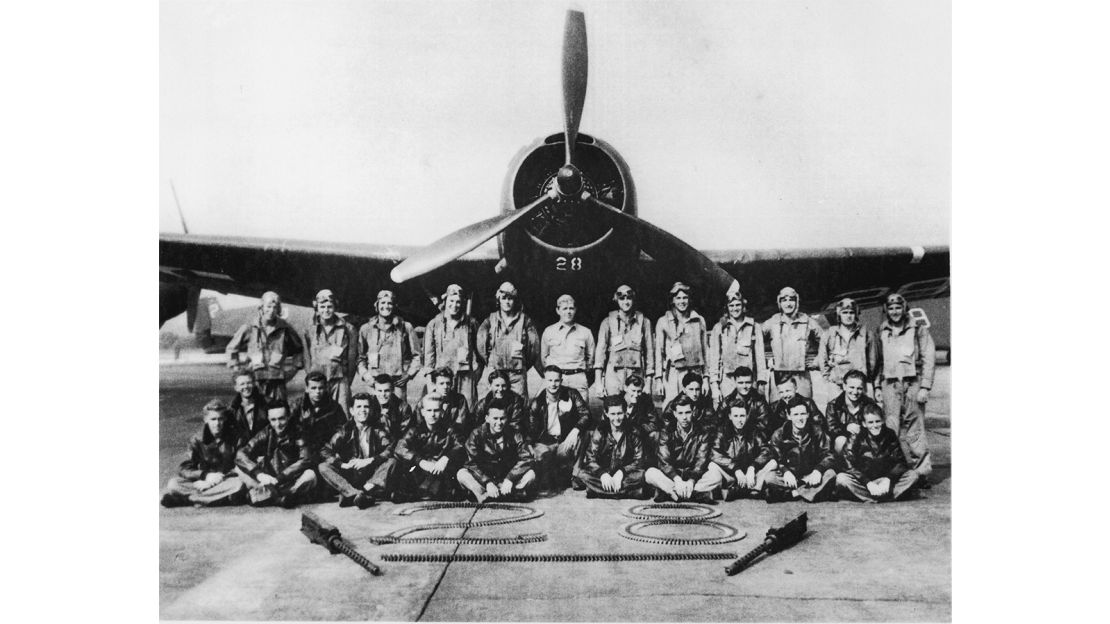 Members of the Navy pose in front of one of the Flight 19 planes that disappeared in 1945.