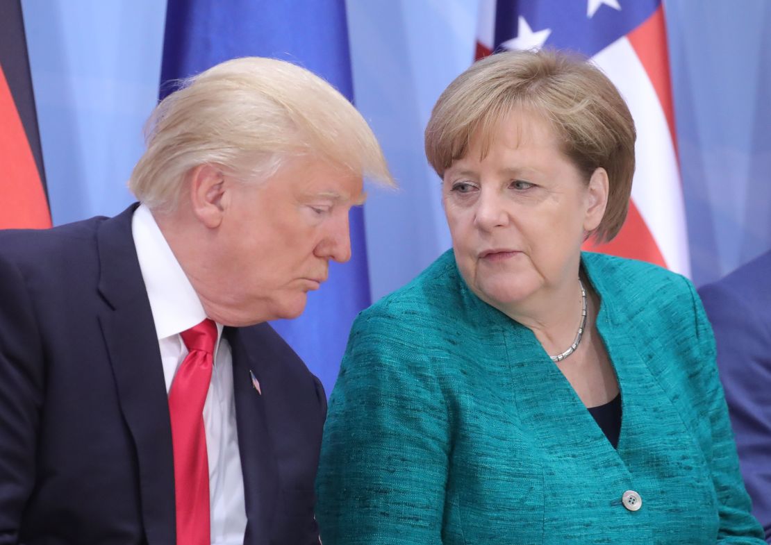 President Donald Trump and German Chancellor Angela Merkel attend a panel discussion Saturday. 