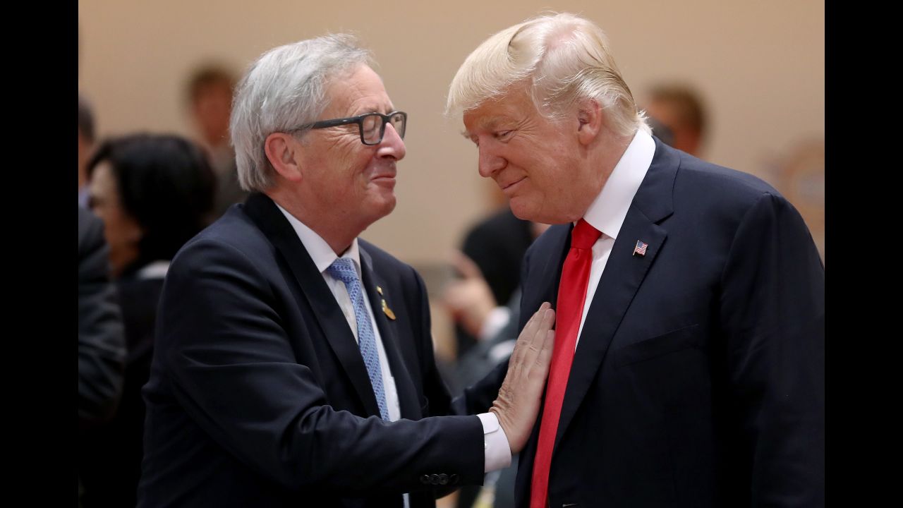 European Commission President Jean-Claude Juncker and Trump chat before the morning working session July 8.