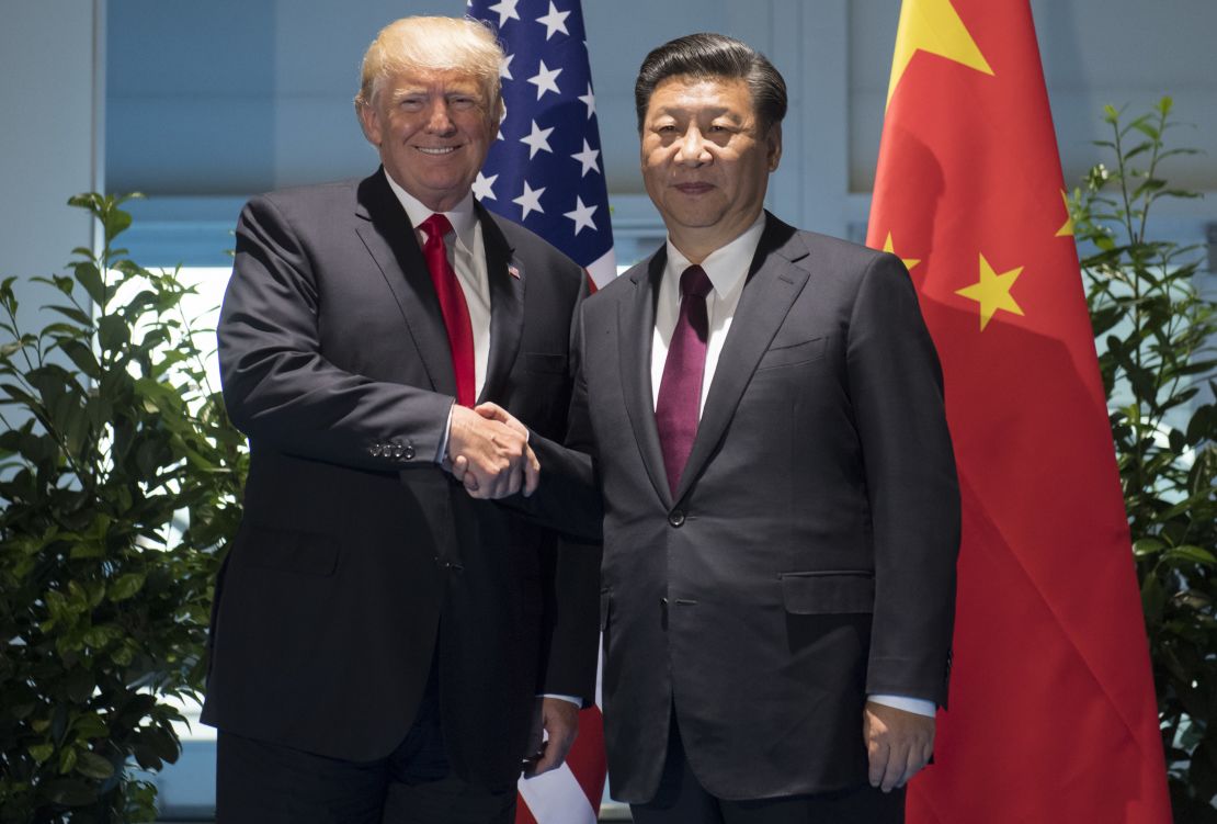 US President Donald Trump and Chinese President Xi Jinping (R) shake hands prior to a meeting on the sidelines of the G20 Summit.