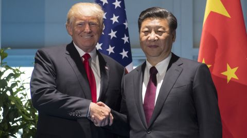 US President Donald Trump and Chinese President Xi Jinping (R) shake hands prior to a meeting on the sidelines of the G20 Summit.