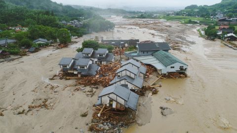 Collapsed houses are half-buried in  mud following the flooding caused by heavy rain in Asakura, Fukuoka prefecture, southwestern Japan.