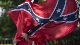 A member of the Ku Klux Klan holds a Confederate flag over his face during a rally, calling for the protection of Southern Confederate monuments, in Charlottesville, Virginia on July 8, 2017.
The afternoon rally in this quiet university town has been authorized by officials in Virginia and stirred heated debate in America, where critics say the far right has been energized by Donald Trump's election to the presidency.
 / AFP PHOTO / ANDREW CABALLERO-REYNOLDS        (Photo credit should read ANDREW CABALLERO-REYNOLDS/AFP/Getty Images)