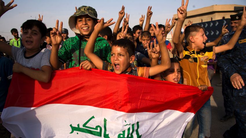 children holding Iraq's national flag react as Iraqi forces celebrate in the Old City of Mosul on July 9, 2017 after the government's announcement of the "liberation" of the embattled city. 
Iraq declared victory against the Islamic State group in Mosul on July 9 after a gruelling months-long campaign, dealing the biggest defeat yet to the jihadist group. / AFP PHOTO / FADEL SENNA        (Photo credit should read FADEL SENNA/AFP/Getty Images)