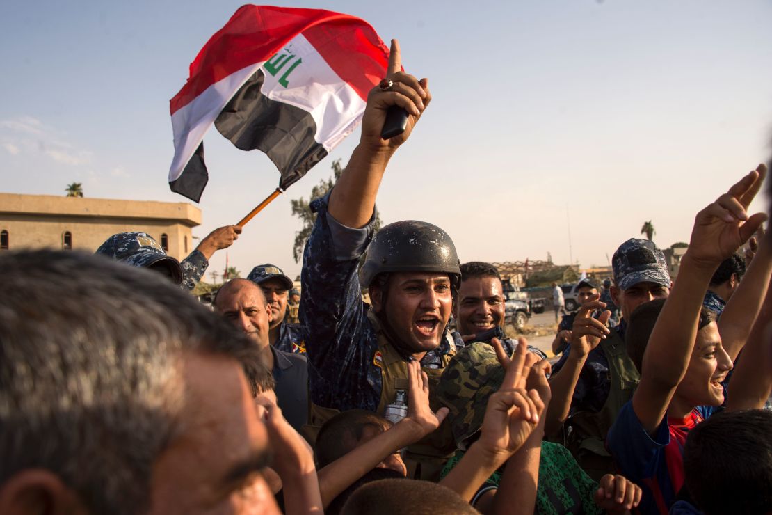 Iraqi forces celebrate the retaking of Mosul on Sunday.