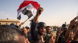 TOPSHOT - Iraq's federal police members wave Iraq's national flag as they celebrate in the Old City of Mosul on July 9, 2017 after the government's announcement of the "liberation" of the embattled city.
Iraq declared victory against the Islamic State group in Mosul on July 9 after a gruelling months-long campaign, dealing the biggest defeat yet to the jihadist group. / AFP PHOTO / FADEL SENNA        (Photo credit should read FADEL SENNA/AFP/Getty Images)