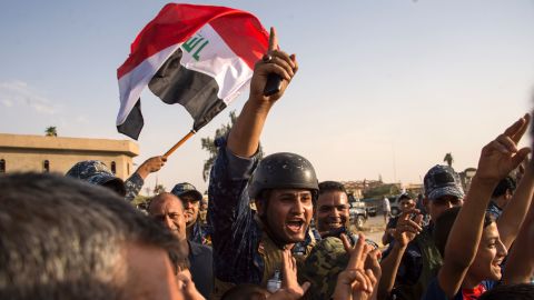 Iraqi forces celebrate the retaking of Mosul on Sunday.