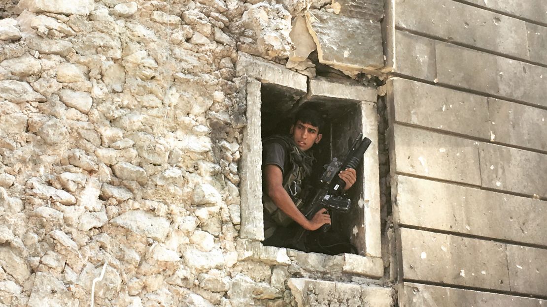 An Iraqi soldier peers from a window amid a battle to rid Mosul of the last remnants of ISIS.