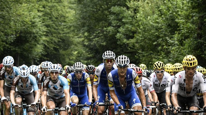 A pack of cyclists rides in the rain during the ninth stage of the Tour de France on Sunday, July 9.