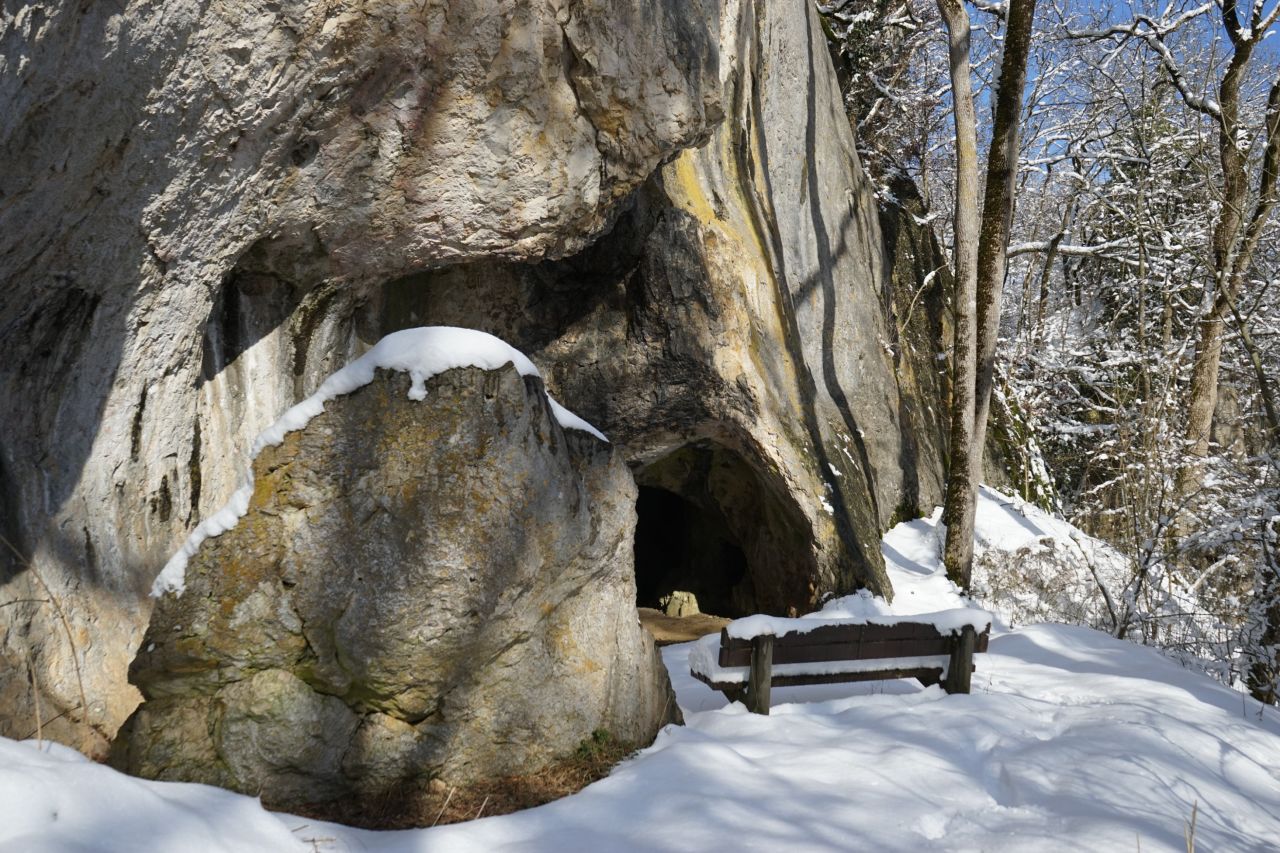 The Sirgenstein Cave is located about 35 meters  above the valley floor to the northwest of the Ach River. Inside the entrance, the broad cave passageway leads into a dome-like hall with two openings in the ceiling.
