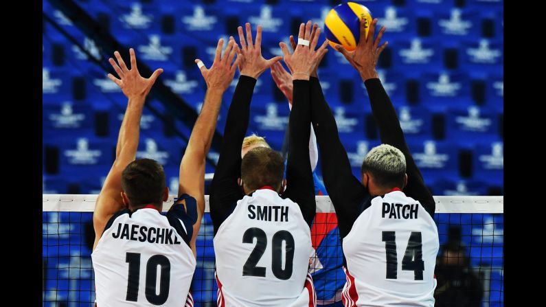 From left, Americans Tom Jaeschke, David Smith and Ben Patch block a Serbian player's spike during a World League volleyball match on Wednesday, July 5. The United States advanced to the semifinals of the tournament but fell short to hosts Brazil. 