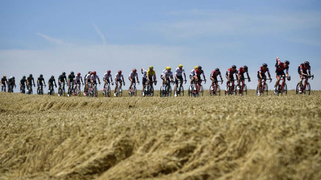 The pack, including Thomas (C) wearing the overall leader's yellow jersey, rides during the 160.5 km fifth stage between Vittel and La Planche des Belles Filles.