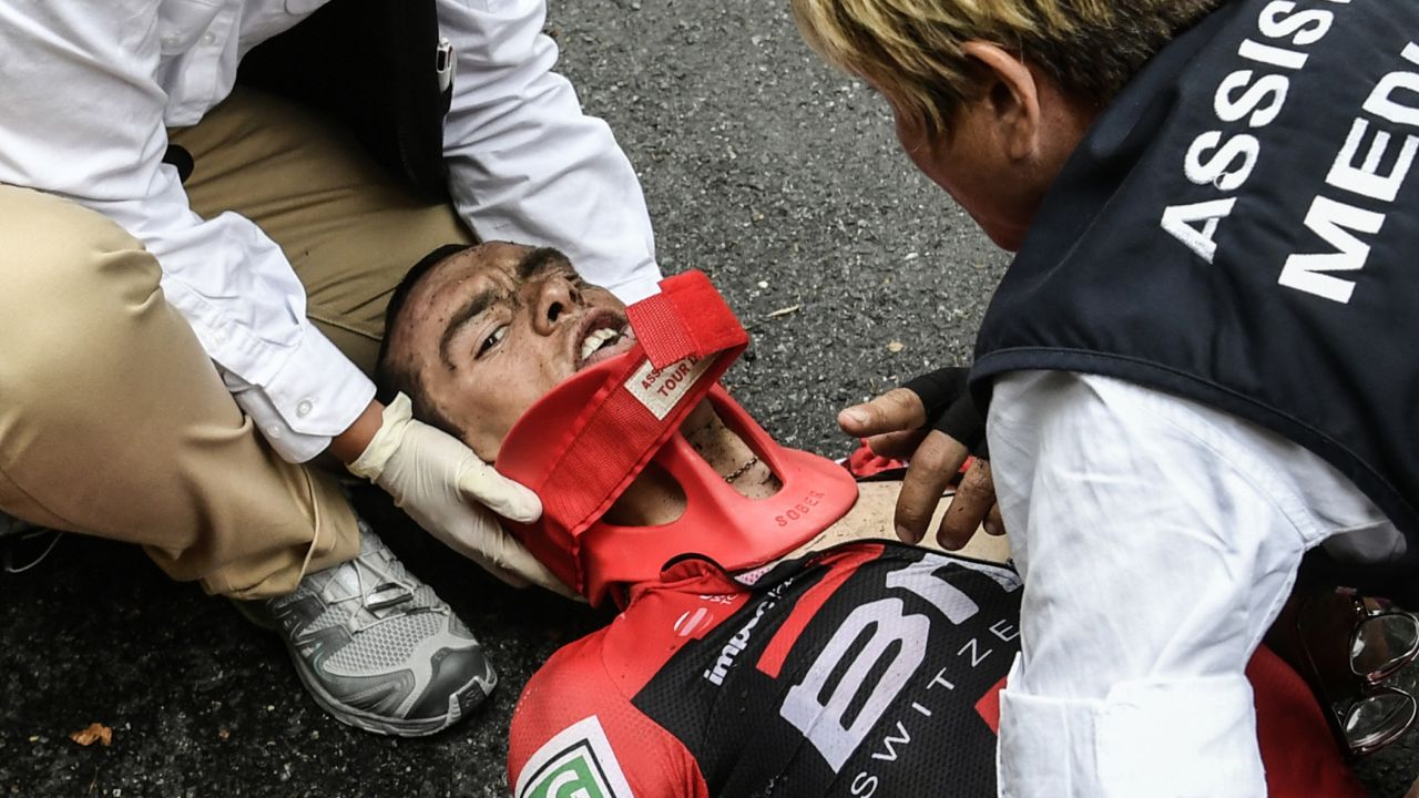 Richie Porte receives medical assistance after his horror crash during stage nine. The Aussie sustained a fractured right collarbone and pelvis on the descent of the Mont du Chat.