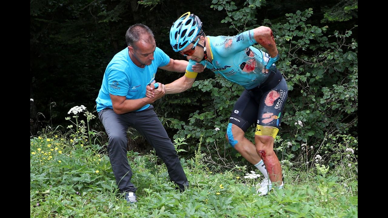 Team Astana's Alexey Lutsenko is helped from the bushes after crashing during stage nine from Nantua to Chambéry. The same corner claimed Lutsenko's teammate Bakhtiyar Kozhatayev as another victim, with Thomas suffering the same fate as the chasing pack arrived minutes later.