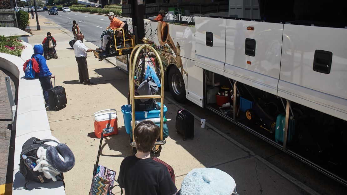 SLIC assistant director Rocky Fuselier boards the bus in a wheel chair.