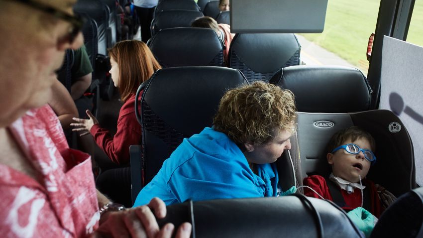 Angela Lorio and her husband, Neil, take care of their son, John Paul, 4, during a bus ride to Washington DC. John Paul needed his  tracheostomy tube cleaned and then experienced a series of complications including vomit, coughing and defecation before they were able to get him stable.   Photo by John Nowak/CNN