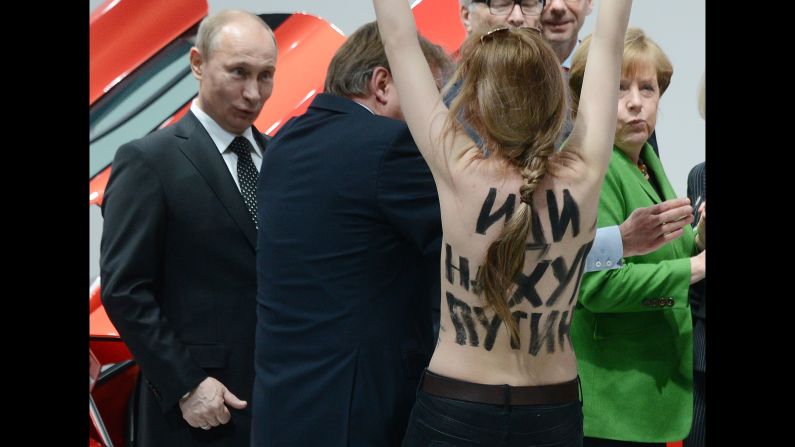 A topless protester shouts at Putin and German Chancellor Angela Merkel during a visit to central Germany in April 2013. That month, Putin <a href="index.php?page=&url=http%3A%2F%2Fwww.cnn.com%2F2013%2F04%2F25%2Fworld%2Feurope%2Frussia-putin-questions%2Findex.html" target="_blank">defended his government's record on free speech</a> and rejected a claim that it uses "Stalinist" methods to clamp down on critics and activists. Two international rights groups had issued scathing reports on Putin's presidency, saying changes to the law had helped authorities stifle dissent. 