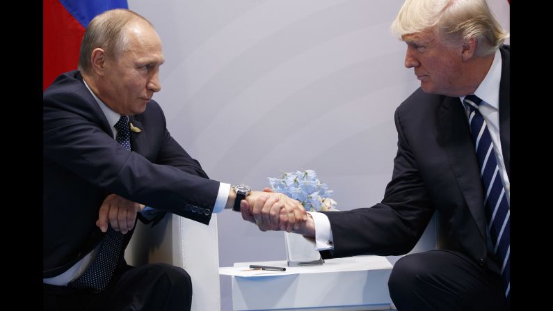 Putin shakes hands with US President Donald Trump <a href="index.php?page=&url=http%3A%2F%2Fwww.cnn.com%2F2017%2F07%2F07%2Fpolitics%2Ftrump-putin-meeting%2Findex.html" target="_blank">as they meet on the sidelines</a> of the G20 summit in Germany in July 2017. They talked for more than two hours, discussing interference in US elections and ending with an agreement on curbing violence in Syria.