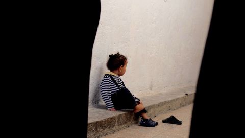 The daughter of an ISIS bride sits on her own in the jail.