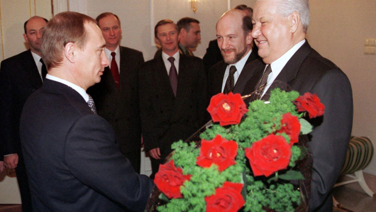 Putin rose quickly through the political ranks. Here, he gives flowers to Russian President Boris Yeltsin during a farewell ceremony in Moscow in December 1999. Yeltsin, Russia's first democratically elected president, was resigning from office. Putin, his prime minister, was appointed acting president until the election, which Putin won several months later.