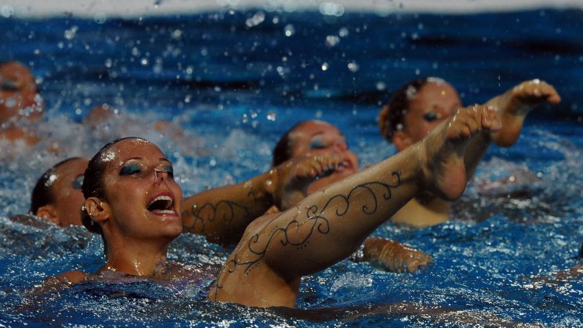 Members of the Hungarian synchronized swimming team perform during the halftime break of the Water Polo European Championships match Hungary vs Spain  in Budapest on July 14, 2014. AFP PHOTO / ATTILA KISBENEDEK        (Photo credit should read ATTILA KISBENEDEK/AFP/Getty Images)