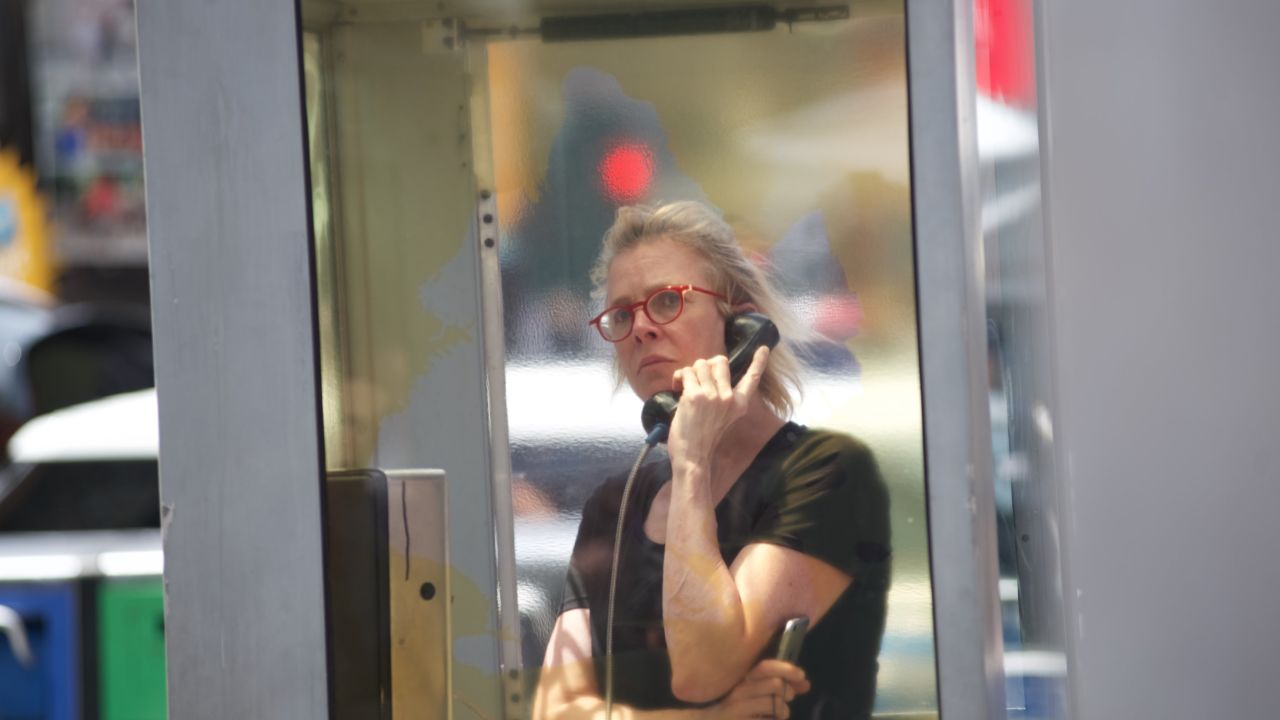 A women listens to "Once Upon a Place," an art installation in Times Square