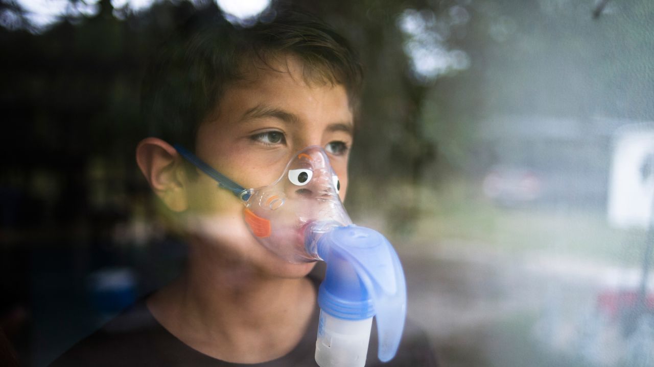 Alejandro Rodriguez wears a nebulizer mask to help him breathe. After he filed a lawsuit, the state put him back on Children's Medical Services.