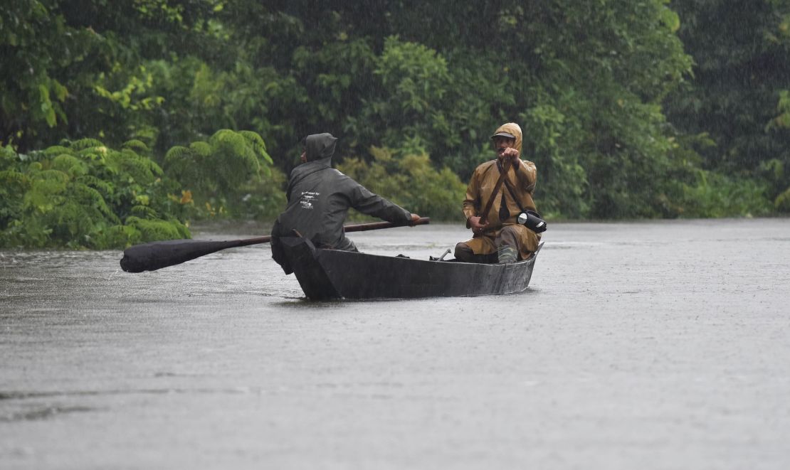 Indian forest guard patroll on a boat A flooded area at Kaziranga National Park, about 250 kilometres east of Guwahati, on July 10, 2017