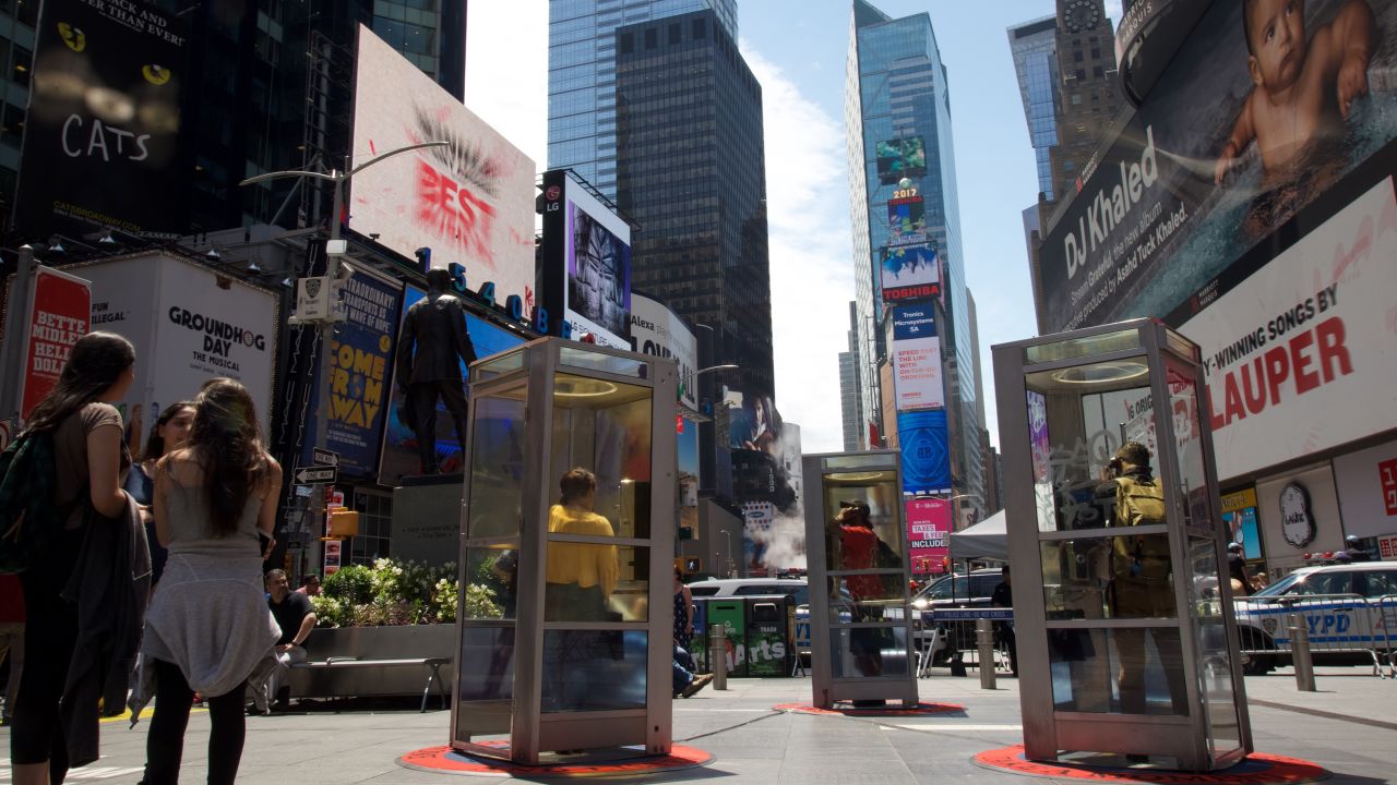 People listening to "Once Upon a Place" art installation in Times Square