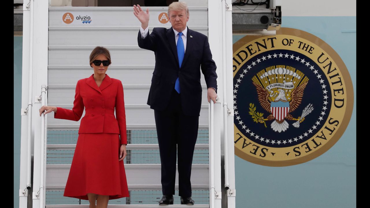 President Trump waves as he and his wife arrive at Paris' Orly Airport.