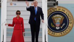 US President Donald Trump waves as he disembarks form Air Force One with First Lady Melania on July 13, 2017 at Paris' Orly airport, beginning a 24 hour trip that coincides with France's national day and the 100th anniversary of US involvement in World War I. (THOMAS SAMSON/AFP/Getty Images)