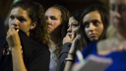 Young women listen to Matthew Weintraub, District Attorney for Bucks County, Pa., speak during a news conference in New Hope, Pa., Thursday, July 13, 2017. Authorities said they've found human remains in their search for four missing young Pennsylvania men and they can now identify one victim. (AP Photo/Matt Rourke)