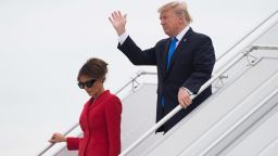 Trump waves as he disembarks from Air Force One with First Lady Melania upon arrival at Paris Orly airport.