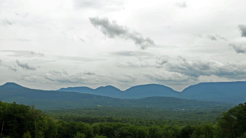 <strong>The mountains:</strong> From rustic log lean-tos above Deer Mountain Inn in Tannersville, a sweeping view of Catskills peaks looking south.