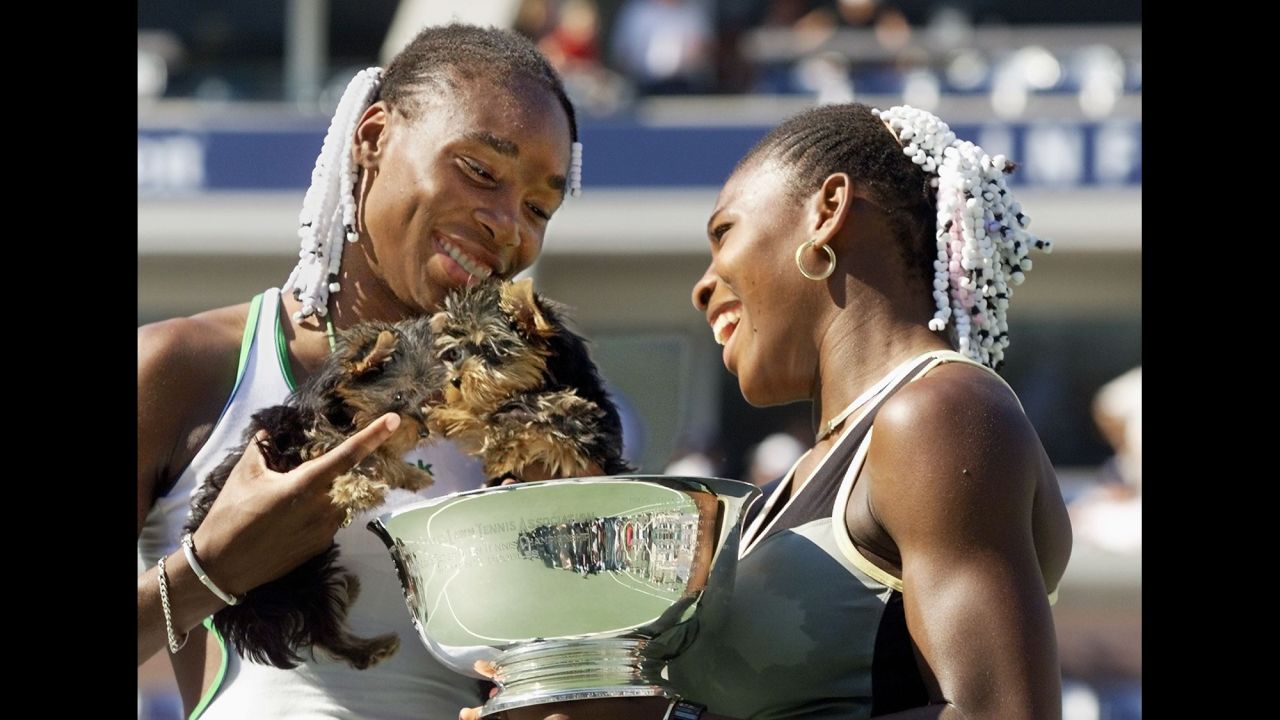 Venus and Serena hold their dogs after winning the US Open doubles title in September 1999.