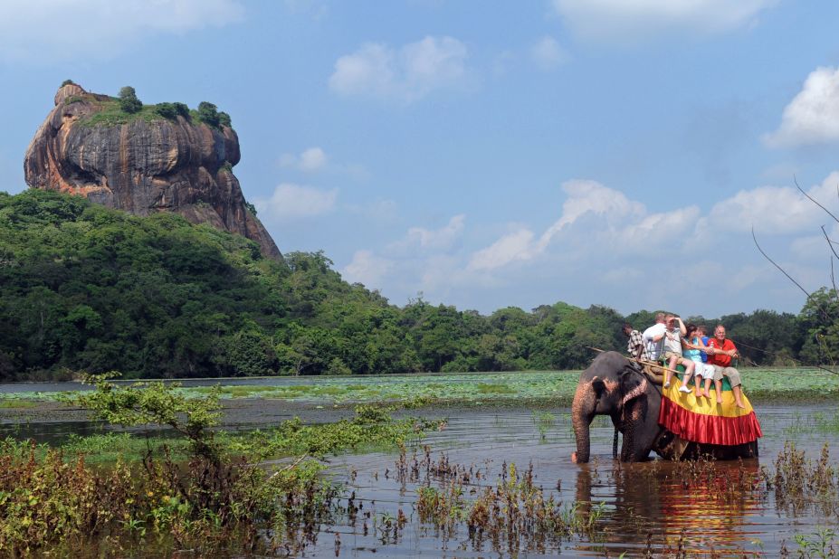 Foreign tourists ride an elephant during a sightseeing tour in the ancient city of Sigiriya -- or Lion Rock -- in Sri Lanka. 