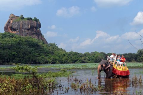 Foreign tourists ride an elephant during a sightseeing tour in the ancient city of Sigiriya -- or Lion Rock -- in Sri Lanka. 