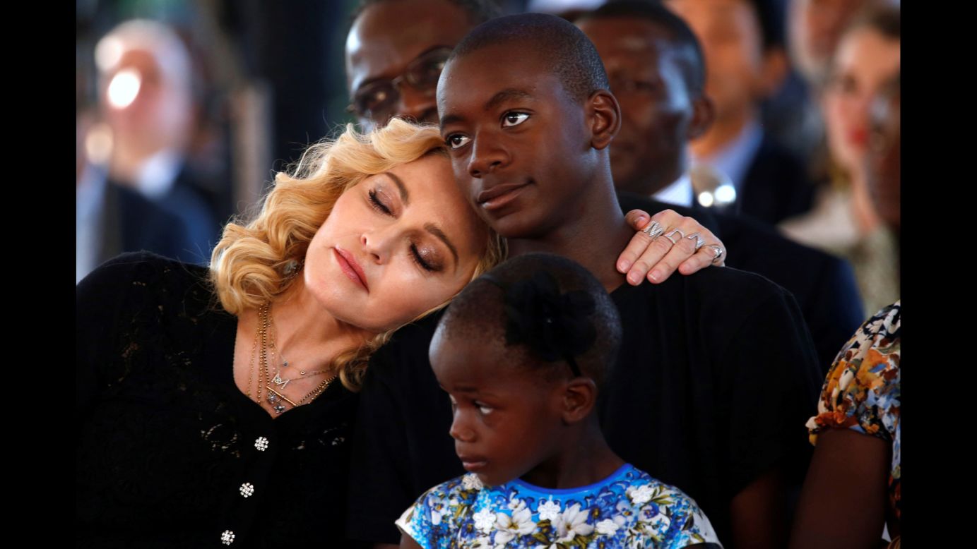 Singer Madonna embraces her son, David Banda, at <a href="http://www.cnn.com/2017/07/12/entertainment/madonna-surgery-center-malawi/index.html" target="_blank">the opening of a children's hospital</a> in Blantyre, Malawi, on Tuesday, July 11. The hospital was funded by Madonna's Raising Malawi charity. Four of her six children -- including David and Stella, who is seen in the foreground -- were adopted from Malawi.