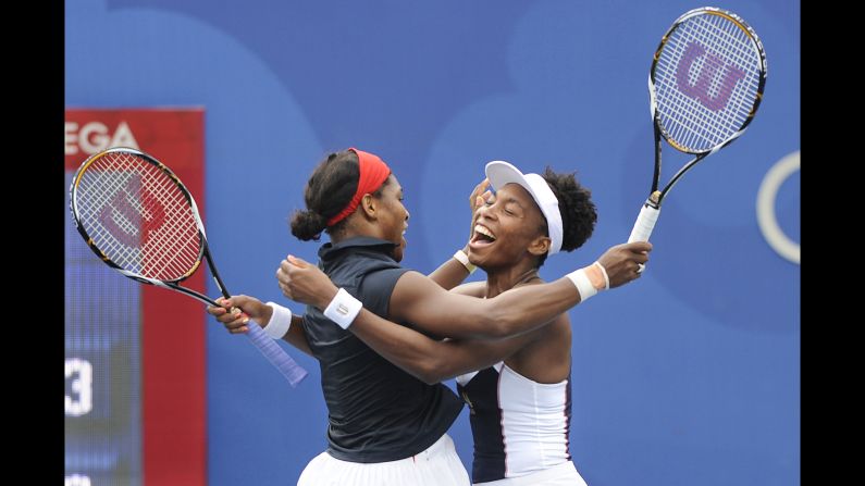 Venus and Serena celebrate winning a gold medal together at the 2008 Beijing Olympics.