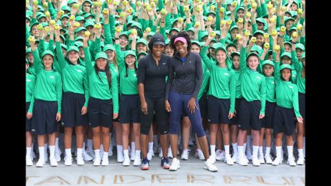 Venus and Serena pose with Australian Open ball kids in January 2017.