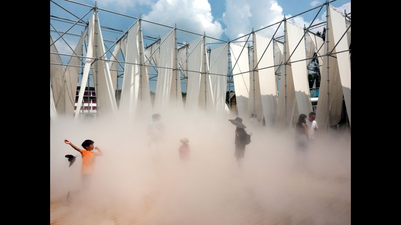 A boy plays in "Mist Encounter," an installation at a fine-arts museum in Taipei, Taiwan, on Tuesday, July 11.
