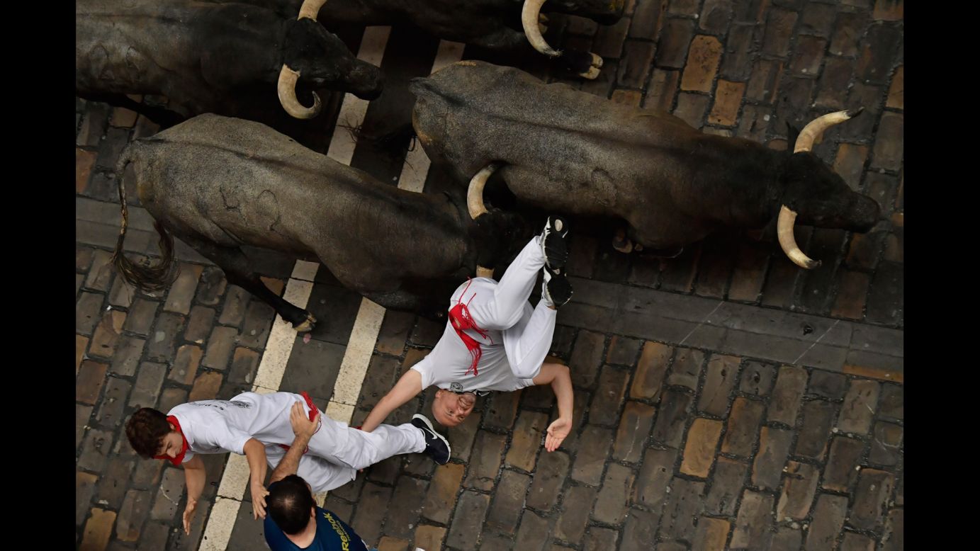 A reveler falls during the annual "running of the bulls" in Pamplona, Spain, on Saturday, July 8.