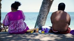 TO GO WITH AFP STORY BY CLAUDINE WERY
People sit along the beach looking out at sea in Noumea on December 1, 2014. Obesity and diabetes are affecting citizens throughout the South Pacific islands, proportionately among the highest in the world, due to the change in eating habits and lifestyles as well as a genetic predisposition. AFP PHOTO/THEO ROUBY        (Photo credit should read THEO ROUBY/AFP/Getty Images)